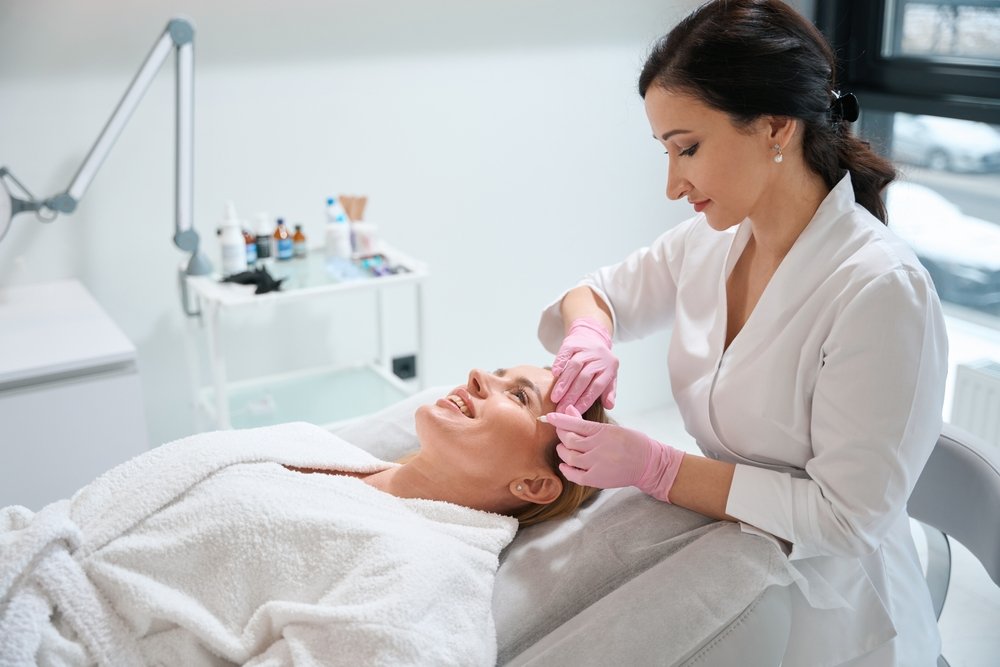 Cosmetologist working on a woman’s face