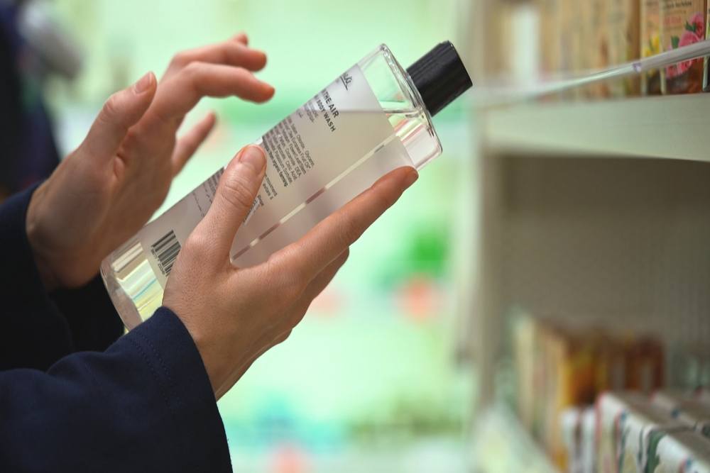 A person checking a beauty product label