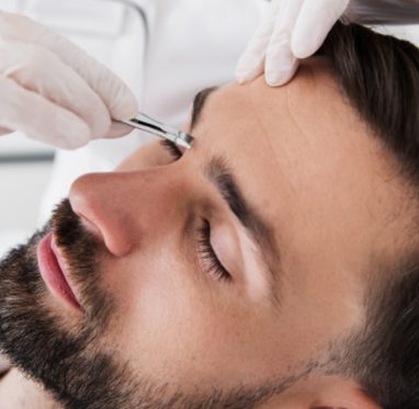 Man getting bro brow as part of men's spa services at Flirt Cosmetics Studio.