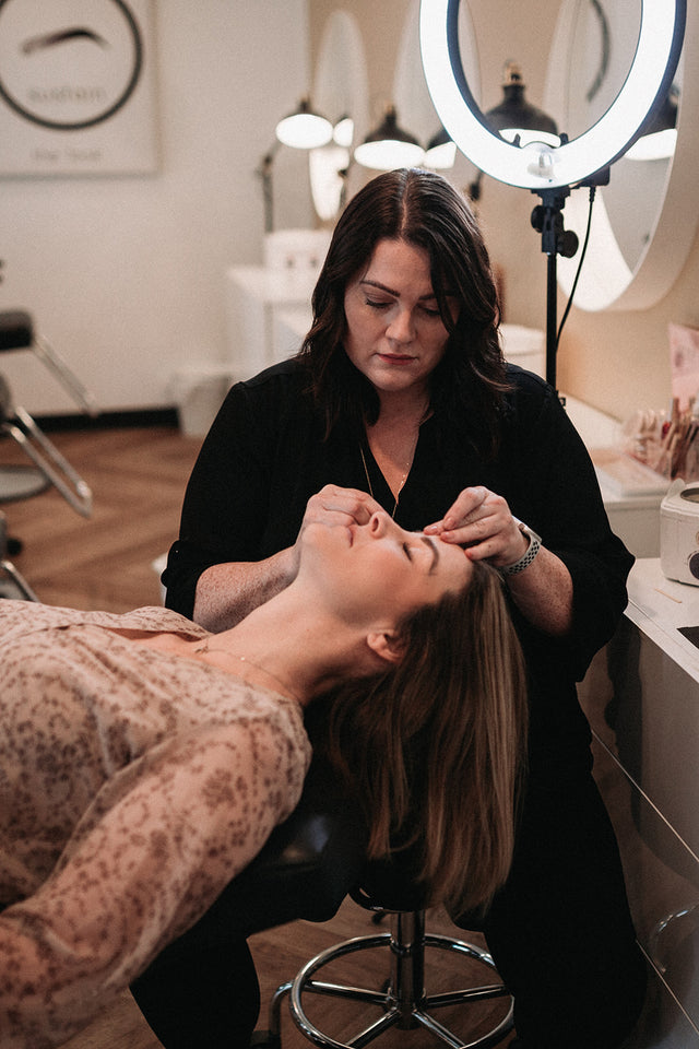 Woman undergoes brow treatment at Flirt Cosmetics Studio Medical Spa